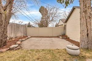 Fenced backyard featuring a patio