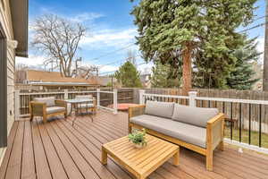 Deck featuring an outdoor living space and a fenced backyard