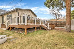 Rear view of property with stairway and a wooden deck