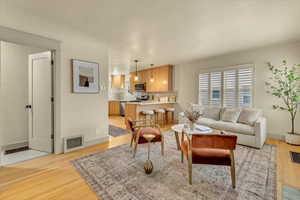 Living room featuring light wood-style floors and baseboards