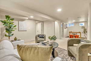 Living room with light carpet and recessed lighting