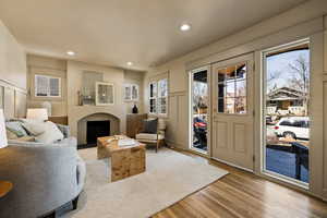 Living area featuring recessed lighting, light wood-style flooring, and a fireplace