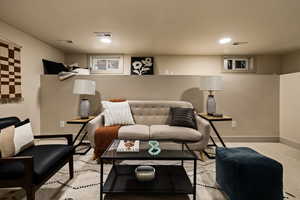 Living area featuring baseboards and recessed lighting