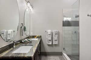 Bathroom with double vanity and a shower stall