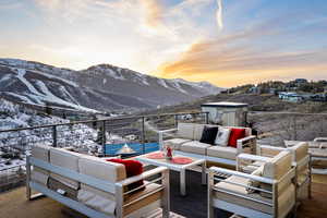 Snow covered deck featuring an outdoor hangout area and a mountain view
