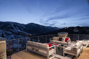 Wooden terrace with a mountain view and an outdoor hangout area