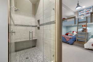 Ensuite bathroom featuring a stall shower