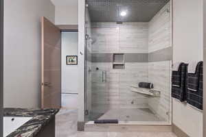 Bathroom with a stall shower, vanity, and tile patterned flooring