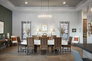 Dining area with wood finished floors and recessed lighting
