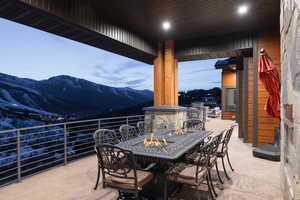 View of patio with outdoor dining area and a mountain view