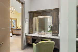 Bathroom featuring vanity and a chandelier