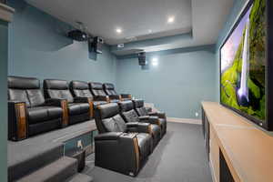 Carpeted cinema with baseboards and recessed lighting