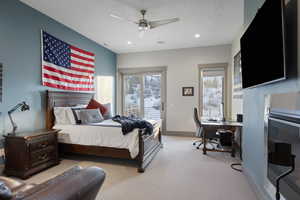 Carpeted bedroom with access to exterior, a desk, recessed lighting, and ceiling fan