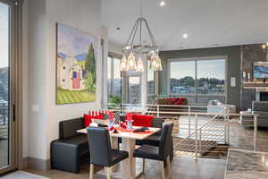 Dining room with wood finished floors, healthy amount of natural light, recessed lighting, and a chandelier