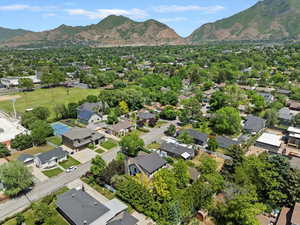 Aerial overview of property's location featuring a mountainous background and nearby suburban area