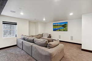 Home theater with carpet floors and recessed lighting