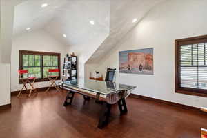 Game room with vaulted ceiling, dark wood-style floors, healthy amount of natural light, and recessed lighting