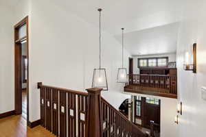 Hall with an upstairs landing and wood finished floors