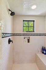 Full bath featuring tiled shower