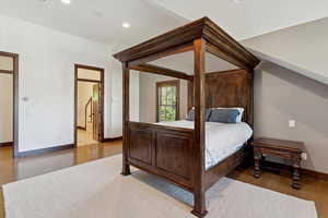 Bedroom with wood finished floors and recessed lighting