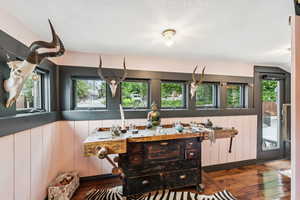 Dining area with wood-type flooring and lofted ceiling