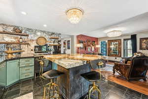 Indoor bar with a chandelier and recessed lighting