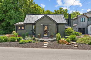 View of front of house featuring a standing seam roof and a metal roof