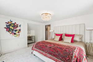 Bedroom with carpet floors and a chandelier