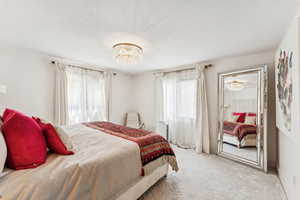 Bedroom featuring carpet floors and a chandelier