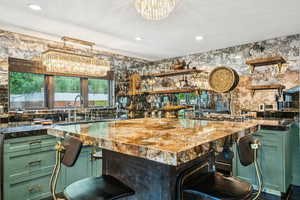Indoor wet bar with a chandelier and recessed lighting