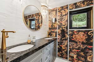Bathroom featuring double vanity and tile patterned flooring