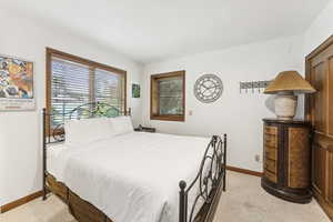 Bedroom featuring light carpet