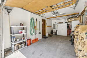 Garage with electric panel and a garage door opener