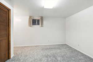 Unfurnished bedroom with carpet and baseboards