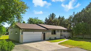 Ranch-style home with a garage and driveway