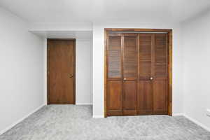 Unfurnished bedroom with a closet and carpet