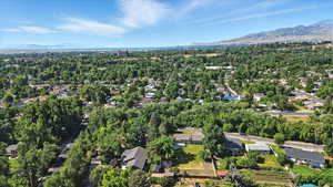 Aerial overview of property's location with a mountain backdrop and nearby suburban area