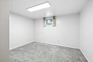 Basement with carpet flooring and baseboards