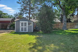 Fenced backyard with a storage shed