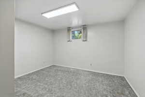 Below grade area featuring carpet and baseboards