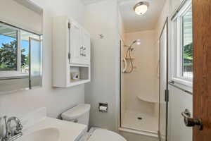 Bathroom featuring a stall shower and vanity