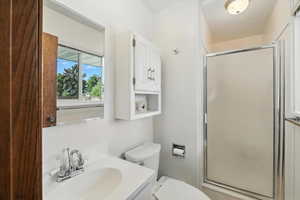 Bathroom featuring a shower stall and vanity