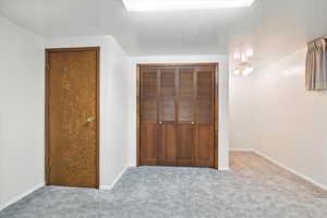 Unfurnished bedroom with carpet and a closet