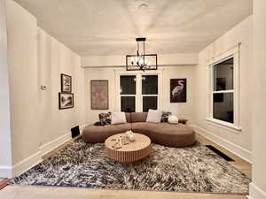Living area with a chandelier and wood finished floors