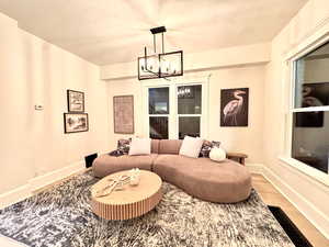 Living room featuring a chandelier and wood finished floors