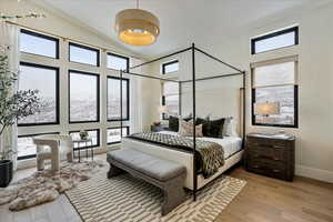 Bedroom with wood finished floors and lofted ceiling