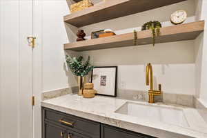 Interior space with open shelves and light stone countertops