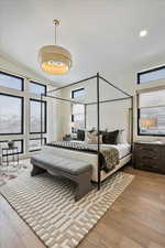 Bedroom with wood finished floors and recessed lighting