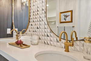 Bathroom view of double vanity and tasteful backsplash