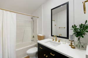 Full bathroom featuring vanity and shower / bath combination with curtain